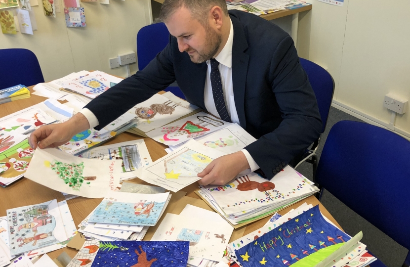 Andrew looking over Christmas Card competition entries