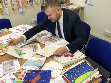 Andrew looking over Christmas Card competition entries